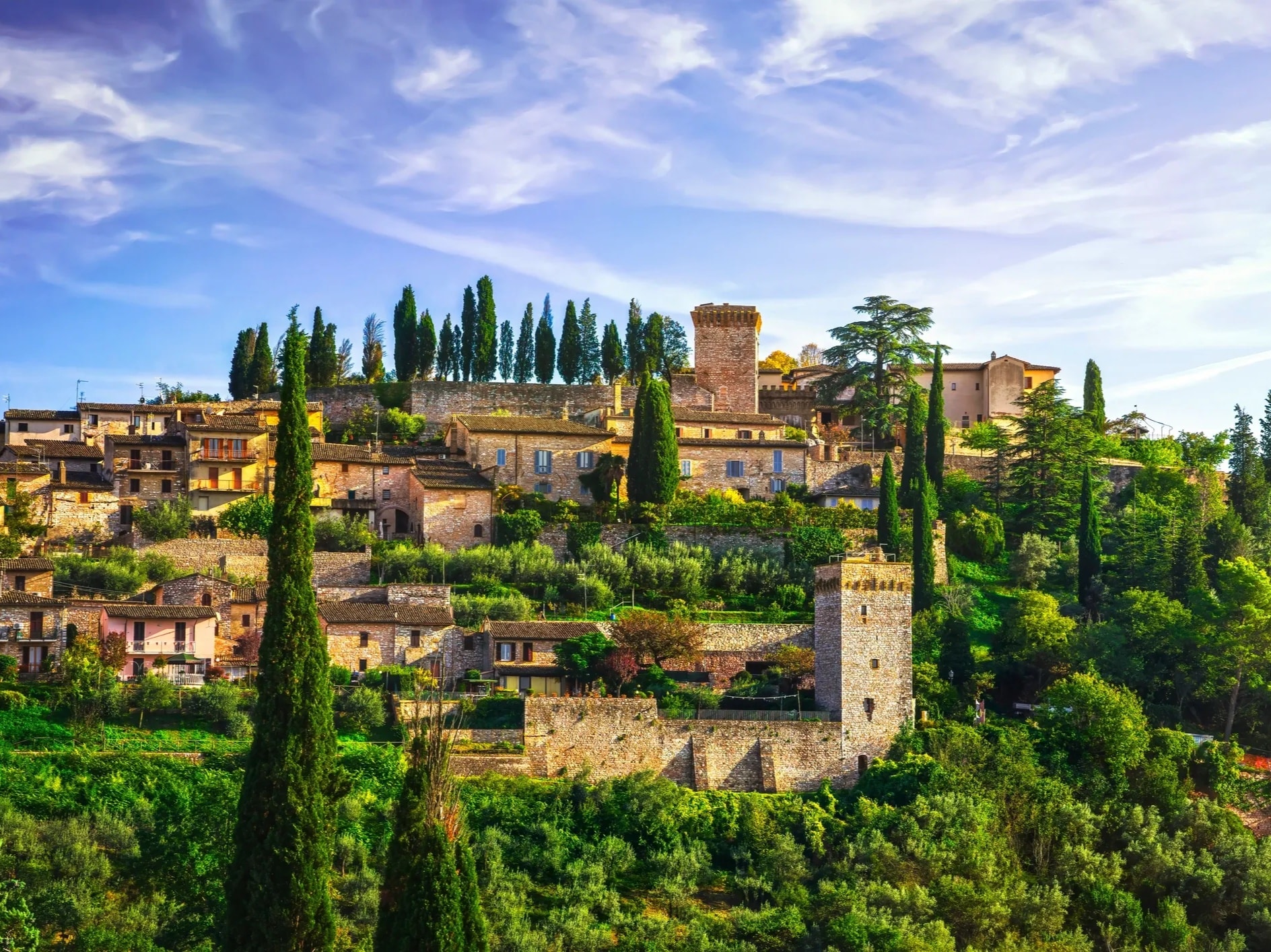 Umbria Italy medieval hilltop village green valley misty morning