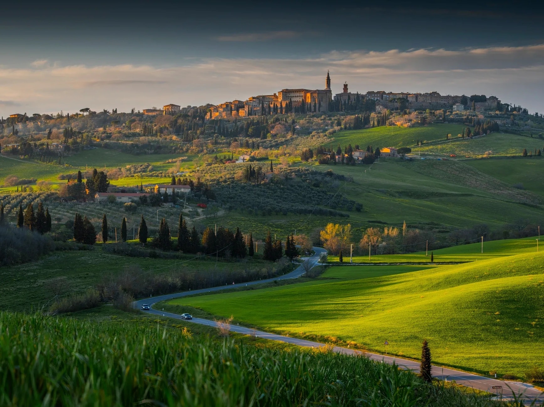 Tuscany winding road cypress trees rolling hills golden light